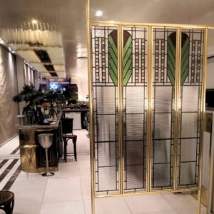 Stained glass screen divider with our glass installation in the background