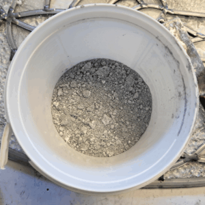 Lead light dry mix scooped into a plastic container